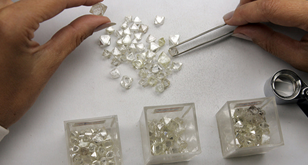 Woman sorting out Shimanky loose diamonds