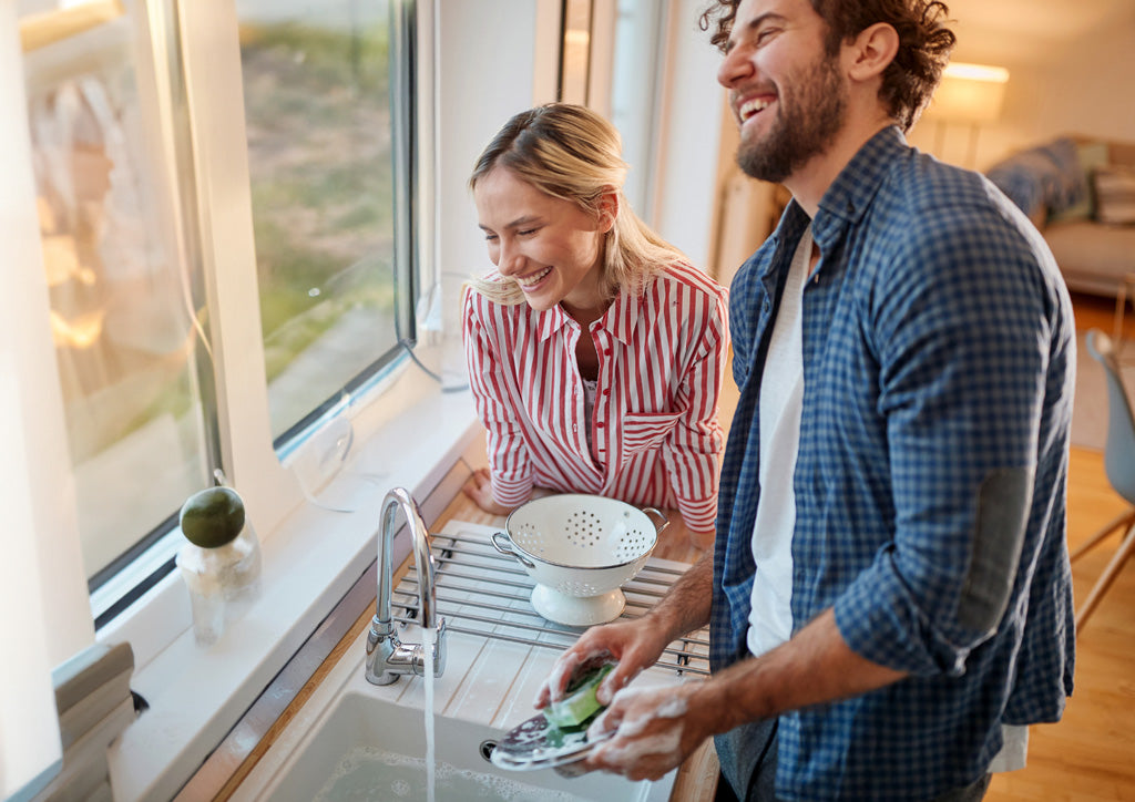 Couple washing dishes celebrating their love for each other