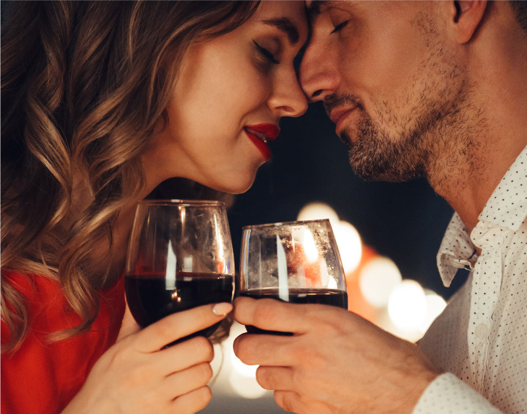 Couple drinking wine sharing an intimate moment