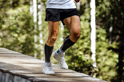 Man running wearing compression socks