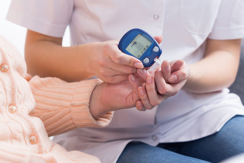 Nurse testing a diabetic's insulin level