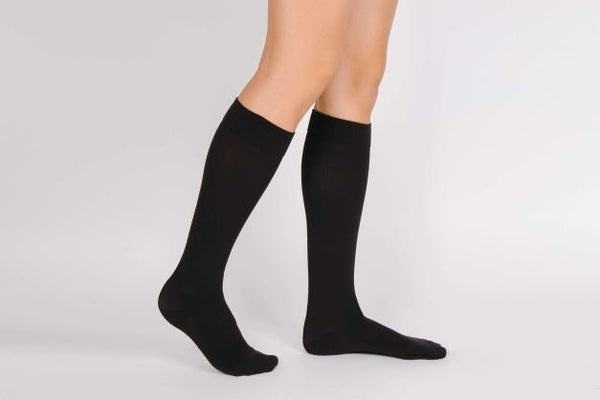 person wearing black compression socks