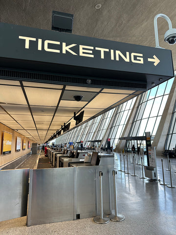 Dulles airport ticketing desk showing the distinctive typeface on a sign that says "Ticketing"