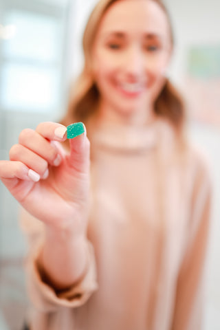 woman holding cbd gummy 