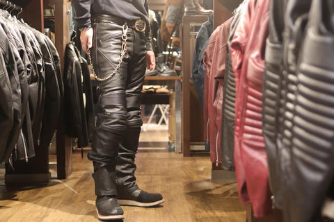 Men trying on leather pants in a department store. Created with