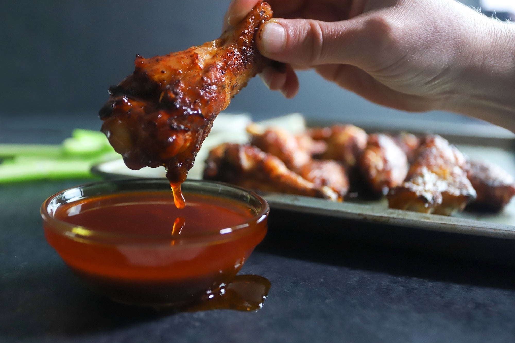 smoked air fryer chicken wings dipped in bbq sauce