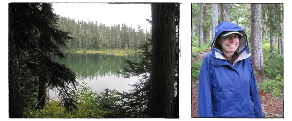 Flapjack lake viewed through some pine trees, Rachel looking chilly and wet but happy in a raincoat