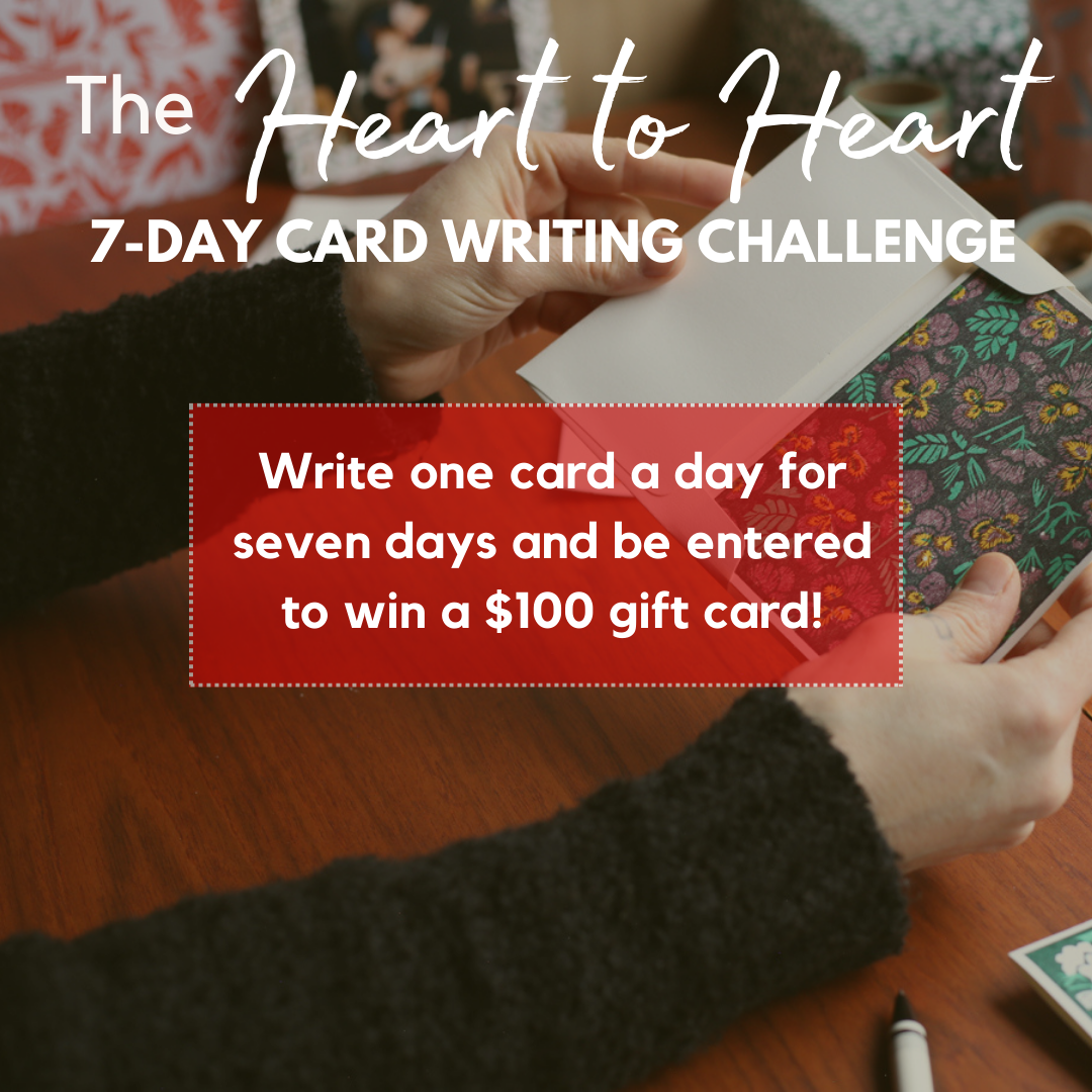 Hands putting a greeting card in an envelope, the text reads 'Write one card a day for seven days and enter to win a free $100 gift card."