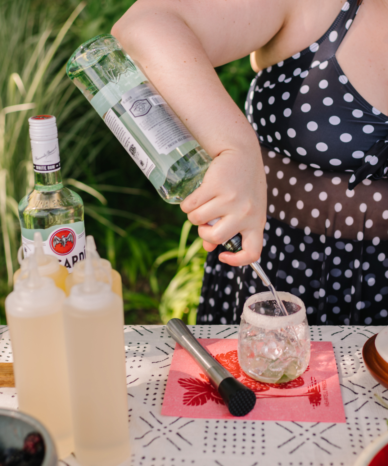 Erin pouring fresh berry mojito into a glass.