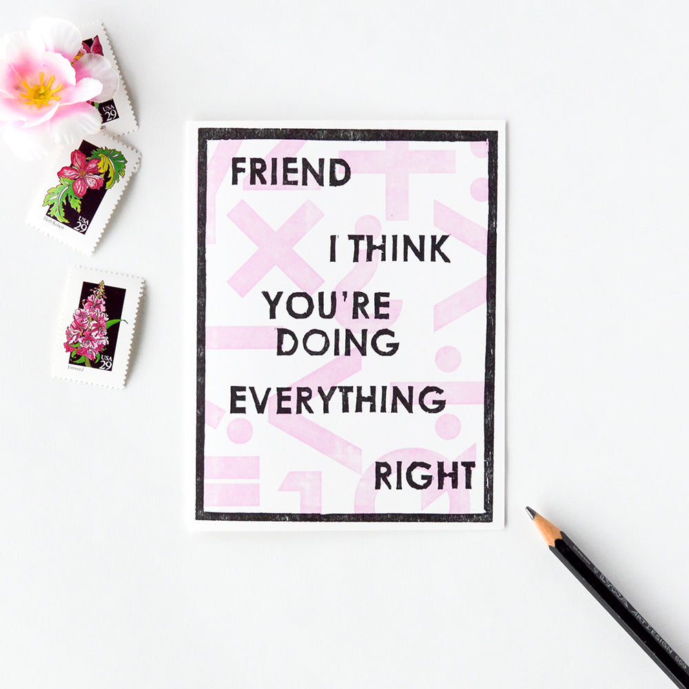 Handmade card that says "Friend I Think You're Doing Everything Right" with a woodcut graphic geometric design of math symbols in pink and black for moms and friends who need encouragement