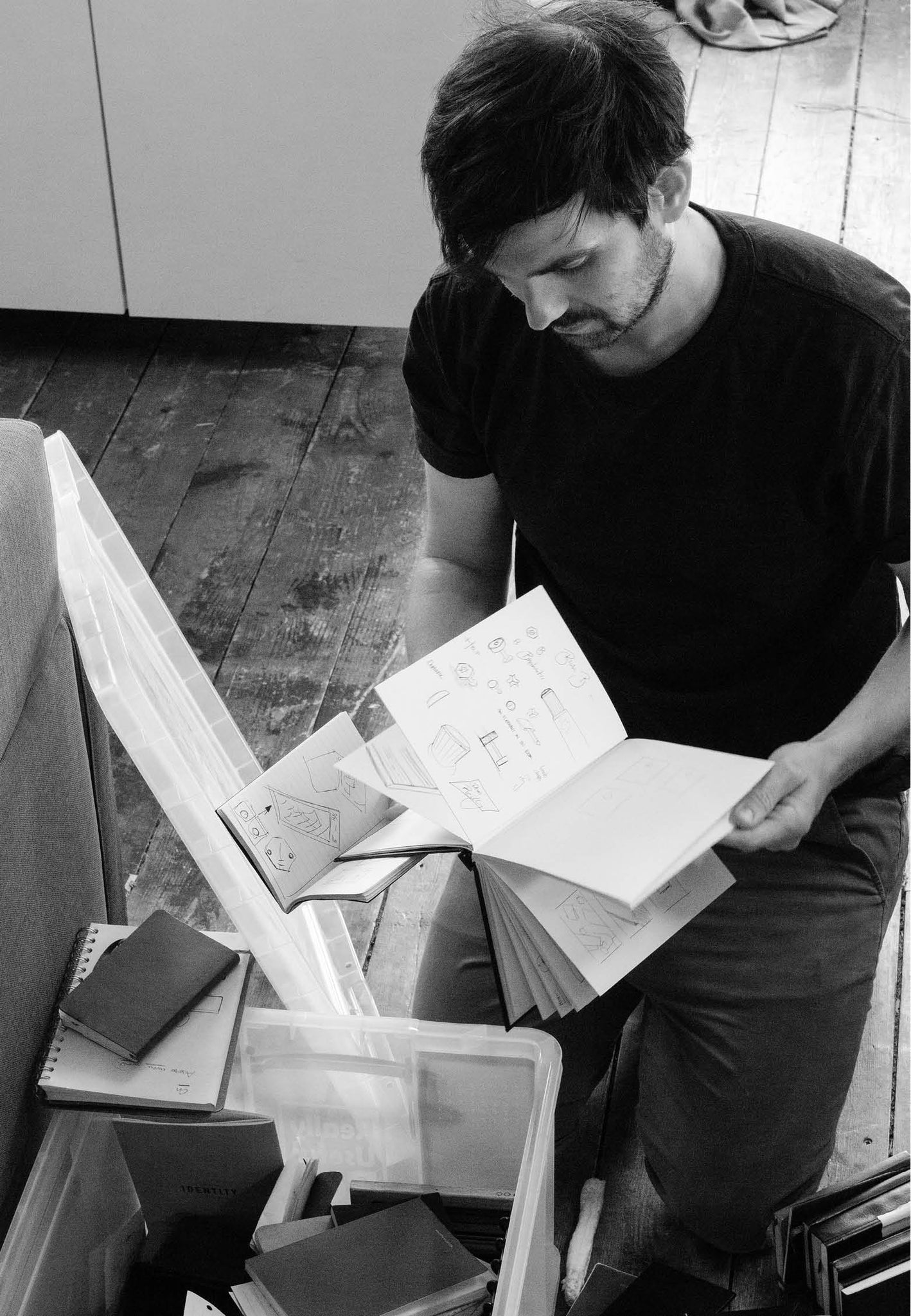 men looking on a pile of notebooks