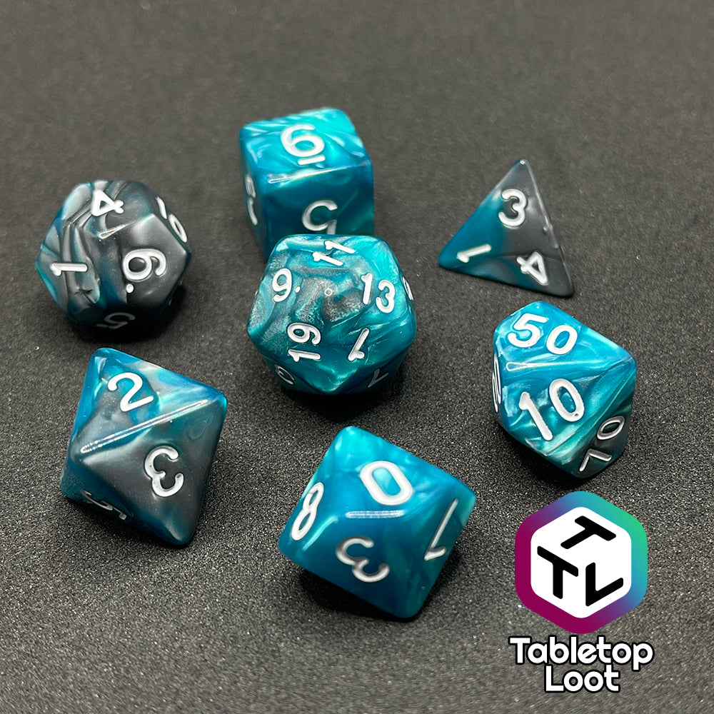 The Hunter's Mark 7 piece dice set from Tabletop Loot with pearlescent swirls of blue and silver and white numbering.