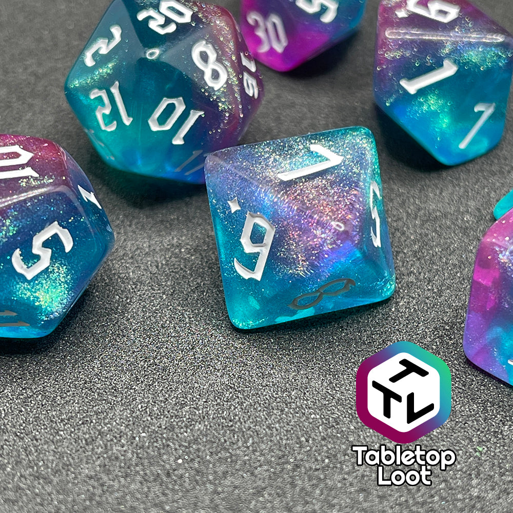 A close up of the D8 from the Mermaid Lagoon 7 piece dice set from Tabletop Loot with shimmery swirls of blue and purple and white gothic numbering.
