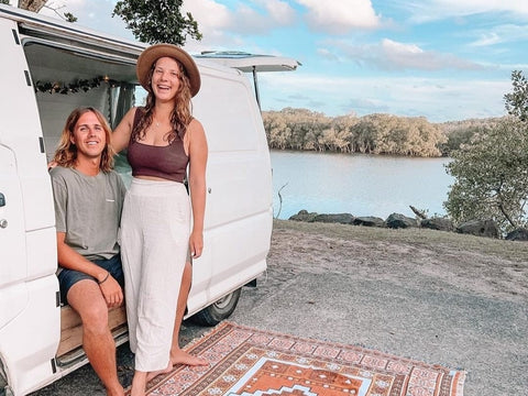 couple sitting in their van by the river