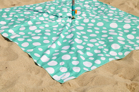 Umbrella pole or Hammering Stake can be placed in center hole of Handy Beach Mat