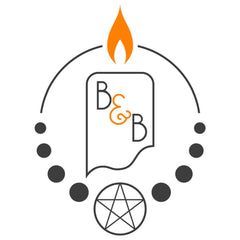 The logo is of a lit candle with B&B on it. A circle is around with dots in the bottom half of the circle and a star in a smaller circle at the base. it is black and white with the exception of the flame and & in an orange color.