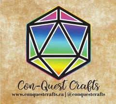 The cursive text reads "Con-Quest Crafts" under a rainbow-gradient die with twenty sides. The background is a light brown splotched with white. In smaller text at the bottom, it reads "www.conquestcrafts.ca | @conquestcrafts"