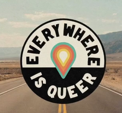 This logo has a location pin at the center with yellow, orange, and a teal color. Surrounding that is a circle that has a white top half and a black bottom half. The top half has the text "EVERYWHERE" in black and the bottom half has the text "IS QUEER" in white. The background is the image of a road with black pavement with painted yellow stripes and a light blue sky with clouds and a yellow to green terrain