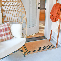 Matterly's Hashtag Personalized doormat featuring the last name Bagley in a black and brown colorway and is placed a front door in order to help protect interior floors from dirt and moisture.