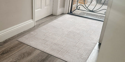 Ultra low-profile rubber backed indoor door rug placed at front door.