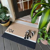 Personalized Matterly doormat with house number placed at covered front door.