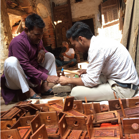 wood carving artisan of india making a handicraft product