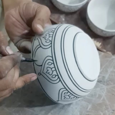 ceramic bowl is getting handpainted