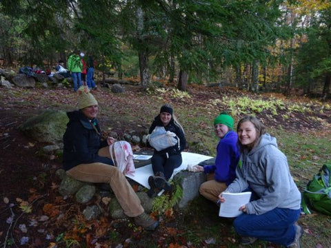 Girls sitting on ground learning skills