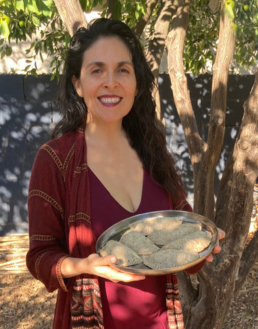 Bianca holding a plate of empanadas