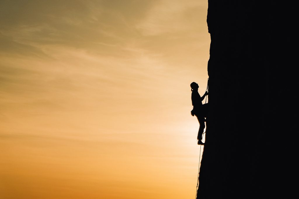 A woman climbing on a vertical rock face