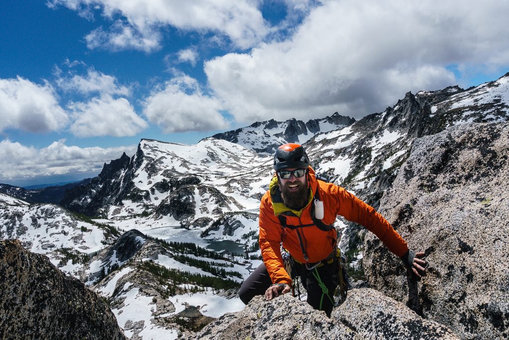 A man reaches a mountain summit