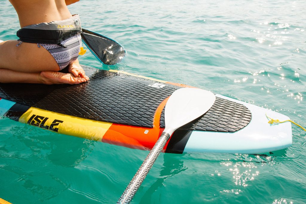 A paddleboard paddle and the tail of the board