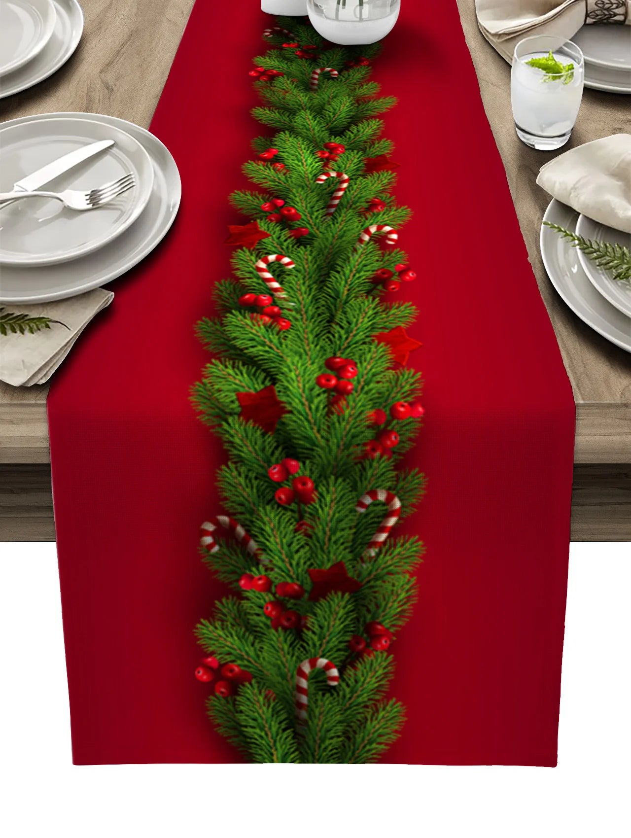 Festive dinner setup featuring red and green holiday table runner.