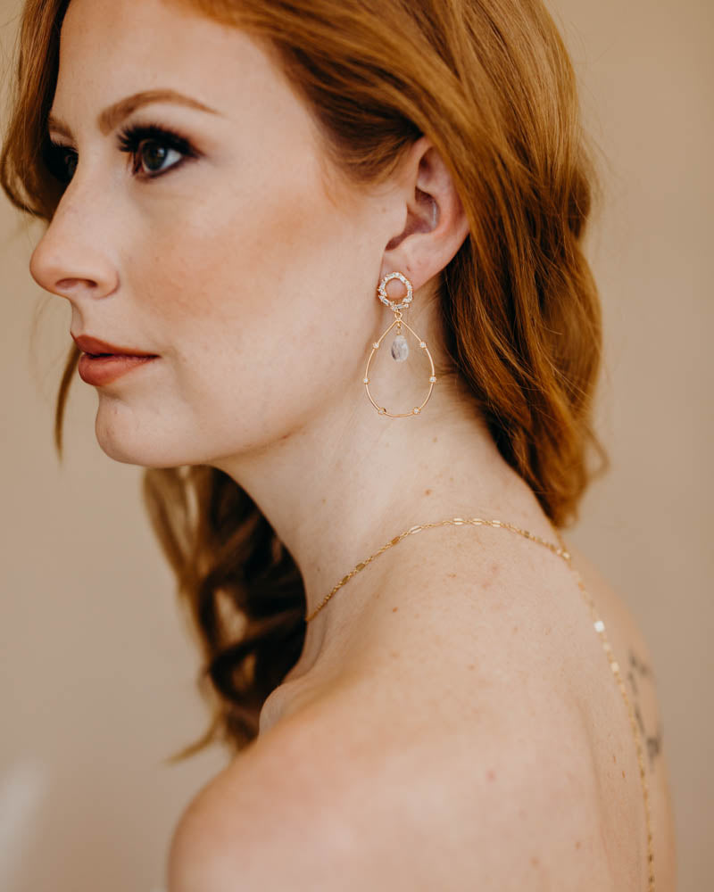 a bride wearing moonstone hoop earrings