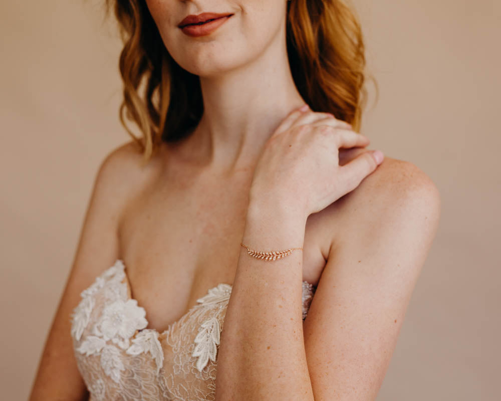 bride wearing leaf bracelet