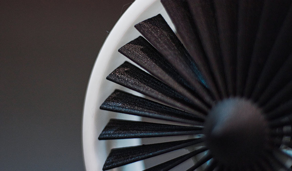 A stunning close-up of a black and white bathroom fan, showcasing intricate details, elegant curves, and delicate lines.