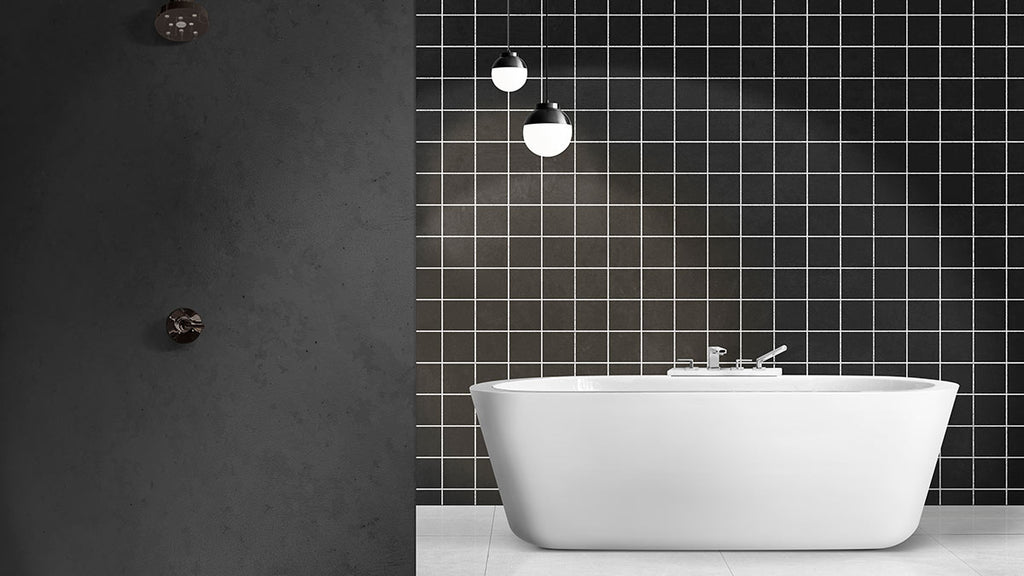 A stylish bathroom with a striking black and white tiled wall, and a white bathtub on a tiled floor, showcasing a contemporary aesthetic.