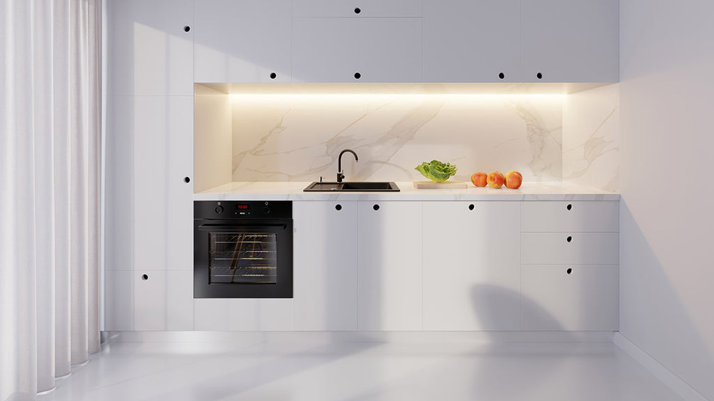 This contemporary kitchen features sleek white cabinets, modern appliances, and is illuminated by LED and natural light from large windows. The design epitomises cleanliness and sophistication.