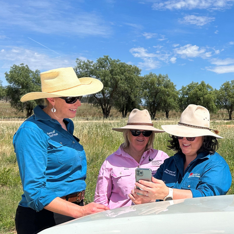 FoTF Staff, Clare Belfield and Ailie Webb, discussing a mobile dashboard with farmer Tess Herbert.