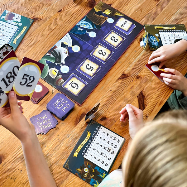 Cool math games for $10 year olds- Picture of girl playing math game, Owl Solve That with family.