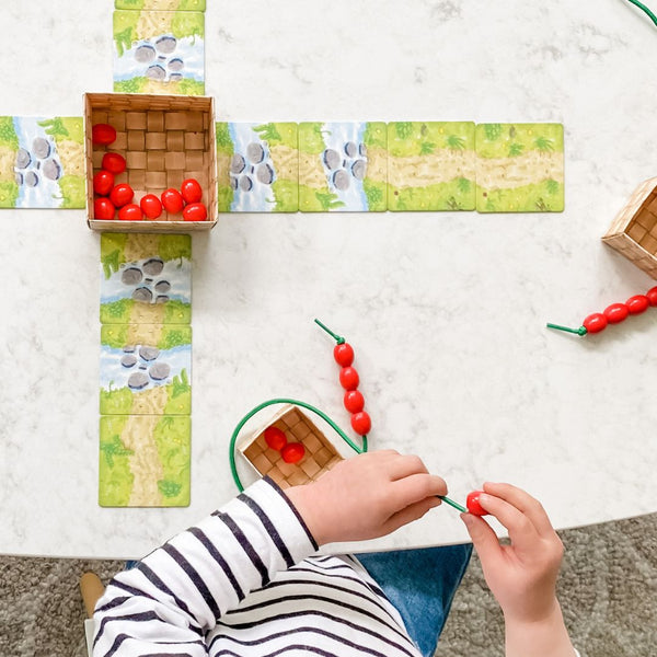 Preschooler playing Share A Berry, early math game. Math card games for kids.