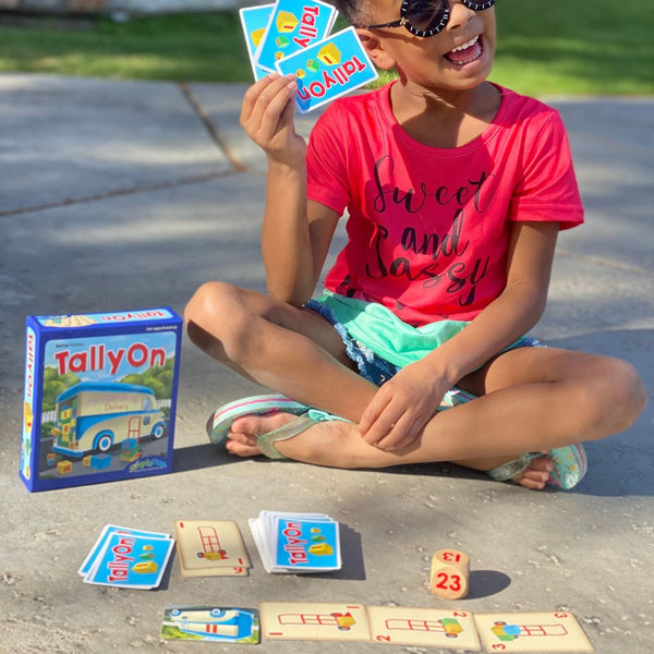 Kindergarten child playing Tally On outdoors, an early county game. Math card games for kids.