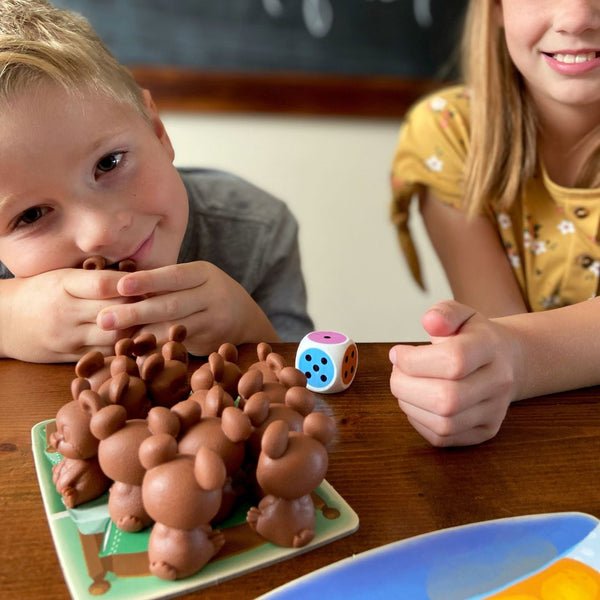 Two kids playing Uncle Beary's Bedtime. Number Recognition Activities for Preschoolers.