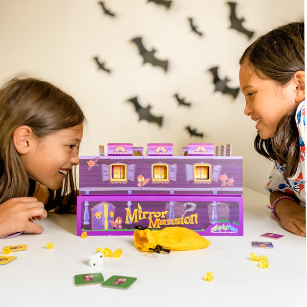 8 year old girls playing cool math game, Mirror Mansion, a fun geometry board game for educational learning.