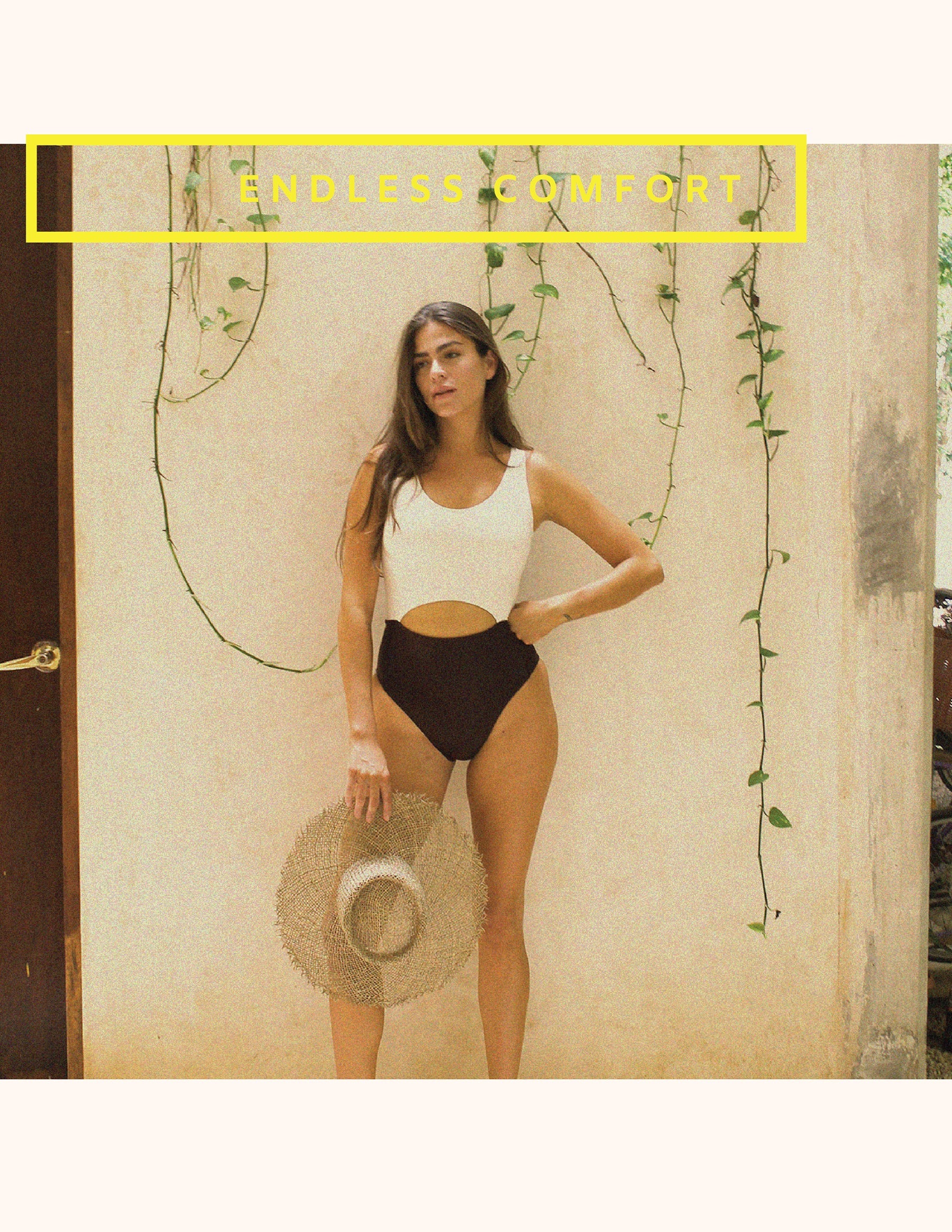 A woman standing wearing her June Swimwear Raya One-Piece in Noyer/Panna Cotta.