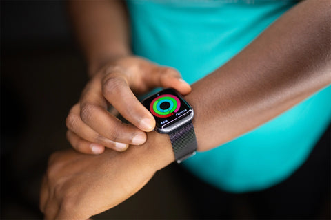 Apple watch activity ring for fitness wearing a silver milanese loop