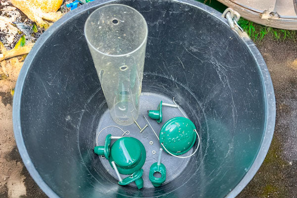 Disassembled bird feeder ready for cleaning