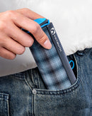 A rolled-up Yotruth XR-10 Solar Power Bank being put into a pocket