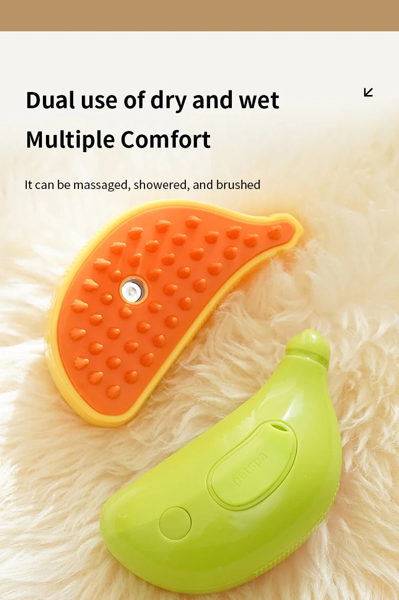 A yellow and orange dual-use pet grooming tool is shown on a fluffy surface. It is designed for massaging, showering, and brushing pets, making it an excellent 3-in-1 Electric Pet Grooming Brush - Cat Steam Brush for Massage, Hair Removal, and More! from The Stuff Box.