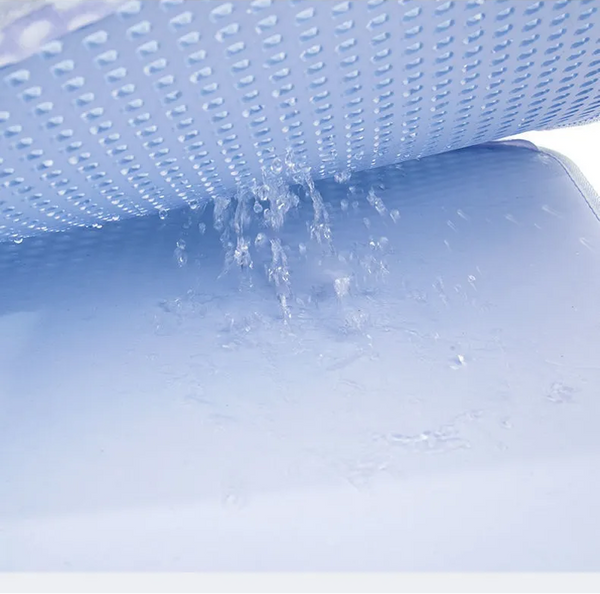 Blue water flows through a perforated surface onto a flat surface below, reminiscent of the innovative double layer design of The Stuff Box Waterproof Cat Litter Mat.